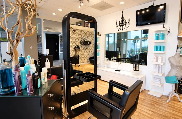 Vered Salon interior with a black styling chair, mirrors and light wood floors